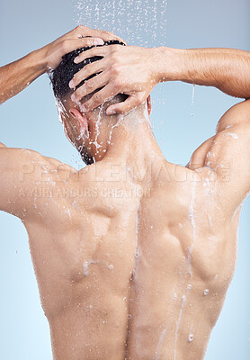 Buy stock photo Shower, soap and man with hair care, grooming and fresh morning bathroom routine on blue background. Health, wellness and male person in water for cleaning, washing and shampoo in studio from back