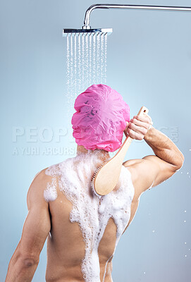 Buy stock photo Shower cap, washing and man with brush for grooming, skincare and morning routine on blue background. Health, wellness and male person in water for cleaning, grooming and hygiene in studio from back