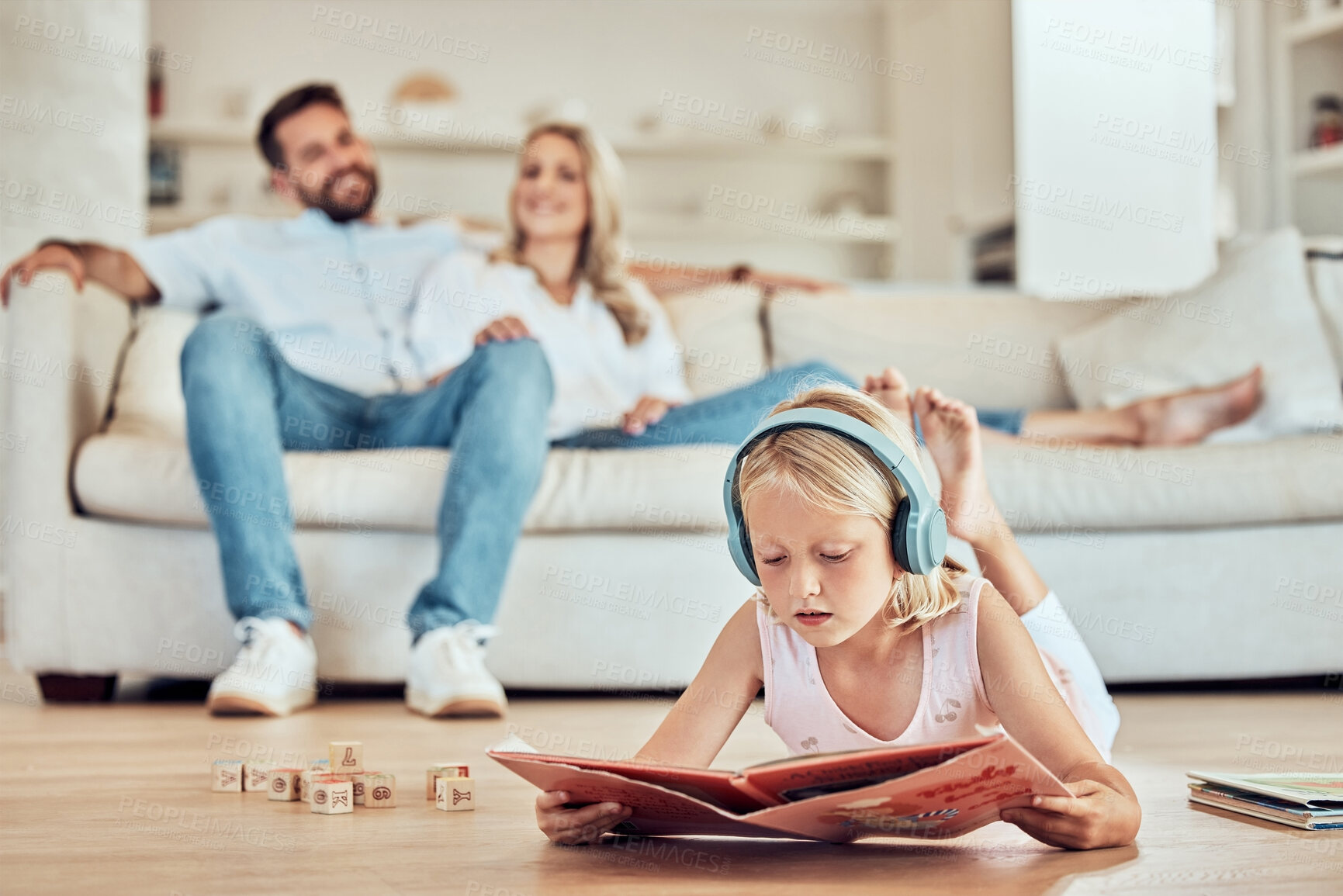 Buy stock photo Girl, child and headphones for reading book in home, online education and podcast for storytelling. Female person, floor and literature for english development, listening and study literacy in lounge