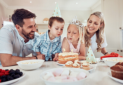 Buy stock photo Happy, family and birthday in home with cake for love, celebration and together for care. Parents, children and party or sweets in living room for weekend and candy in kitchen for nutrition or eating