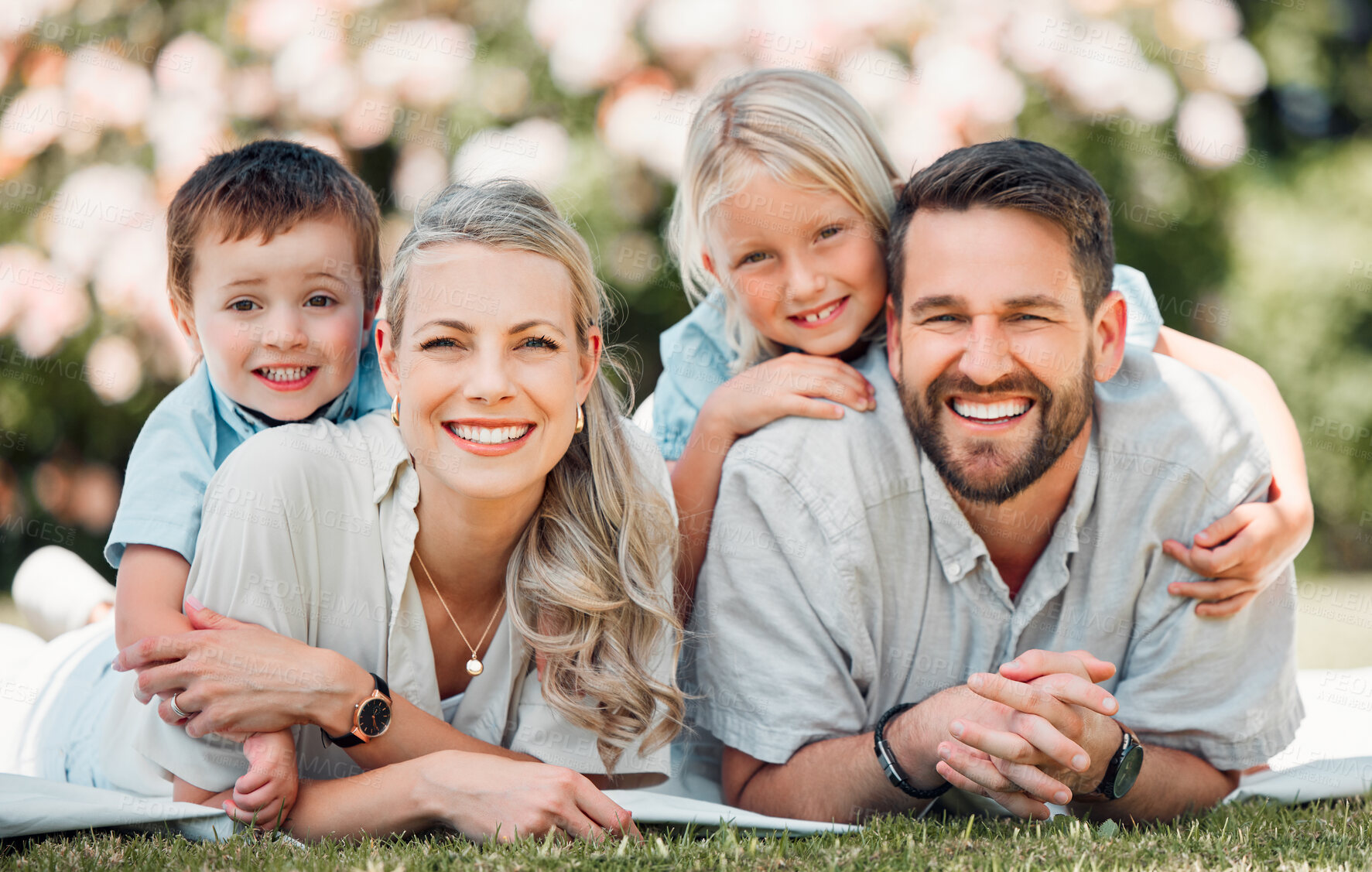 Buy stock photo Portrait, family and grass for picnic, nature and outdoor to relax in summer, love and bonding in break. Parents, woman and man with children, happy and weekend for connecting with young kids in park