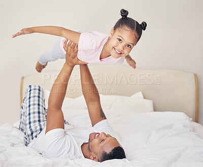 Buy stock photo Father, daughter and airplane on bed with child for bonding, happiness or playing together in bedroom. Morning, man parent and young kid with balance for family fun, support or lift in air of home