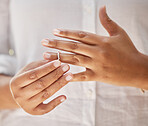 Close up of female hands removing wedding ring. Woman taking off ring after her divorce. Woman breaking off engagement and ending relationship