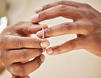 Close up of man removing wedding band. Male hands taking off ring before going out to cheat. Finalising divorce