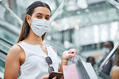 Buy stock photo Portrait, woman and face mask with shopping bags in mall for retail fashion, purchase and luxury commerce in virus compliance. Female customer, paper bag and clothes of designer brand in quarantine 