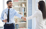 Two mixed race businesspeople in handshake after signing contract in interview. Hispanic applicant meeting CEO, hiring manger. Candidate hired for job opening, vacancy, office opportunity, promotion