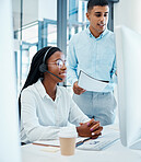 Call center manager discussing clients with a help desk operator waring a headset. A trainer onboarding new staff and teaching them how to be great at customer service and support. A team working.