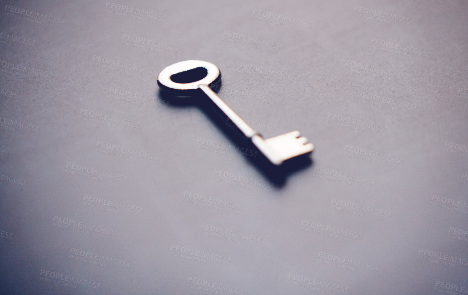 Buy stock photo Key, security and investment with metal on gray background, new home and opportunity for real estate in studio. Unlock, future and entry tool for potential growth, space and property or house access
