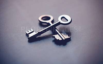 Buy stock photo Keys, security and investment with metal on gray background, new home and opportunity for real estate in studio. Unlock, future and entry tool or potential growth, space and property or house access
