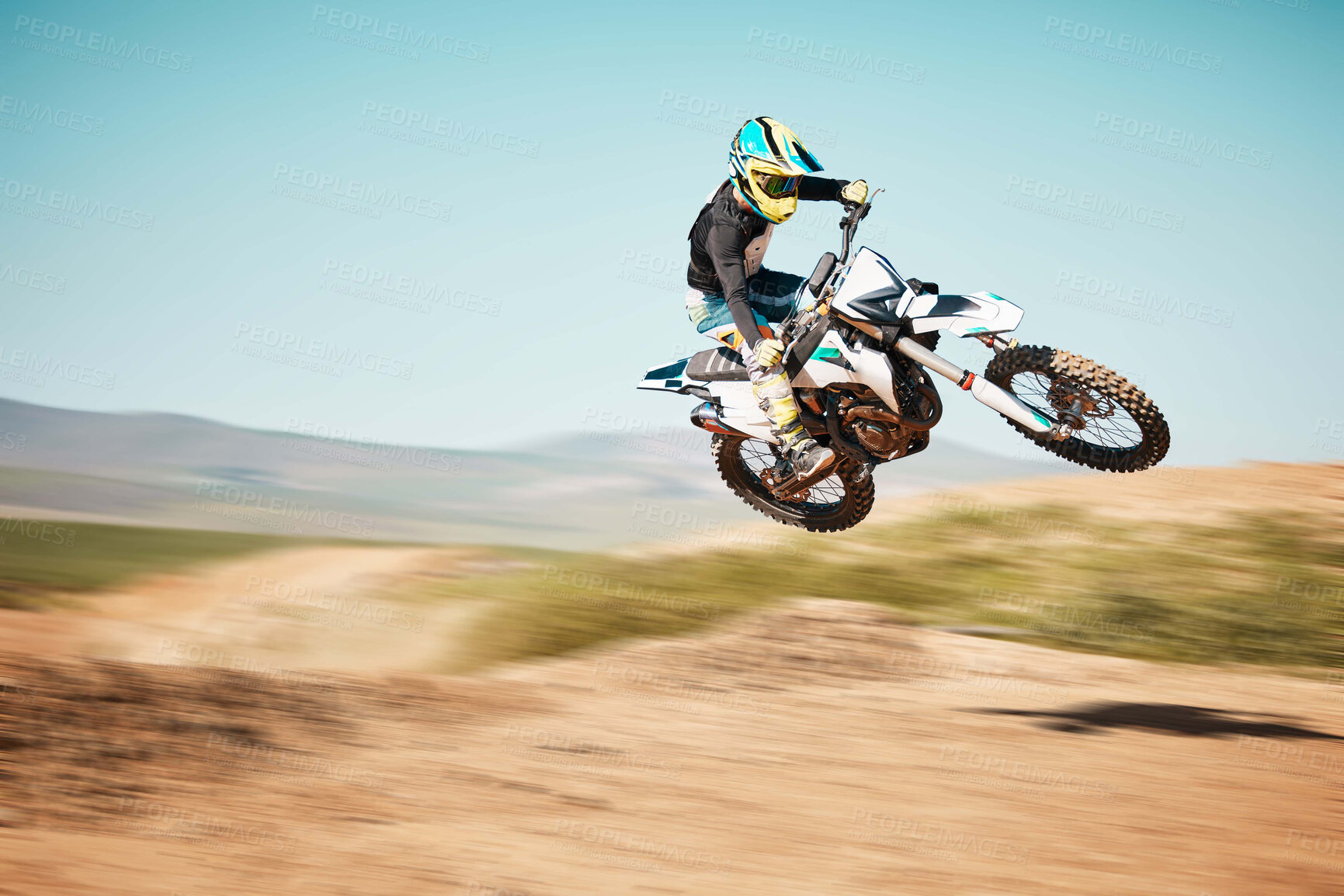 Buy stock photo Motorcross, air jump and offroad sports with motion blur, speed challenge or desert. Driver, cycling and stunt on dirt track, competition and motorbike performance on adventure course for fast action