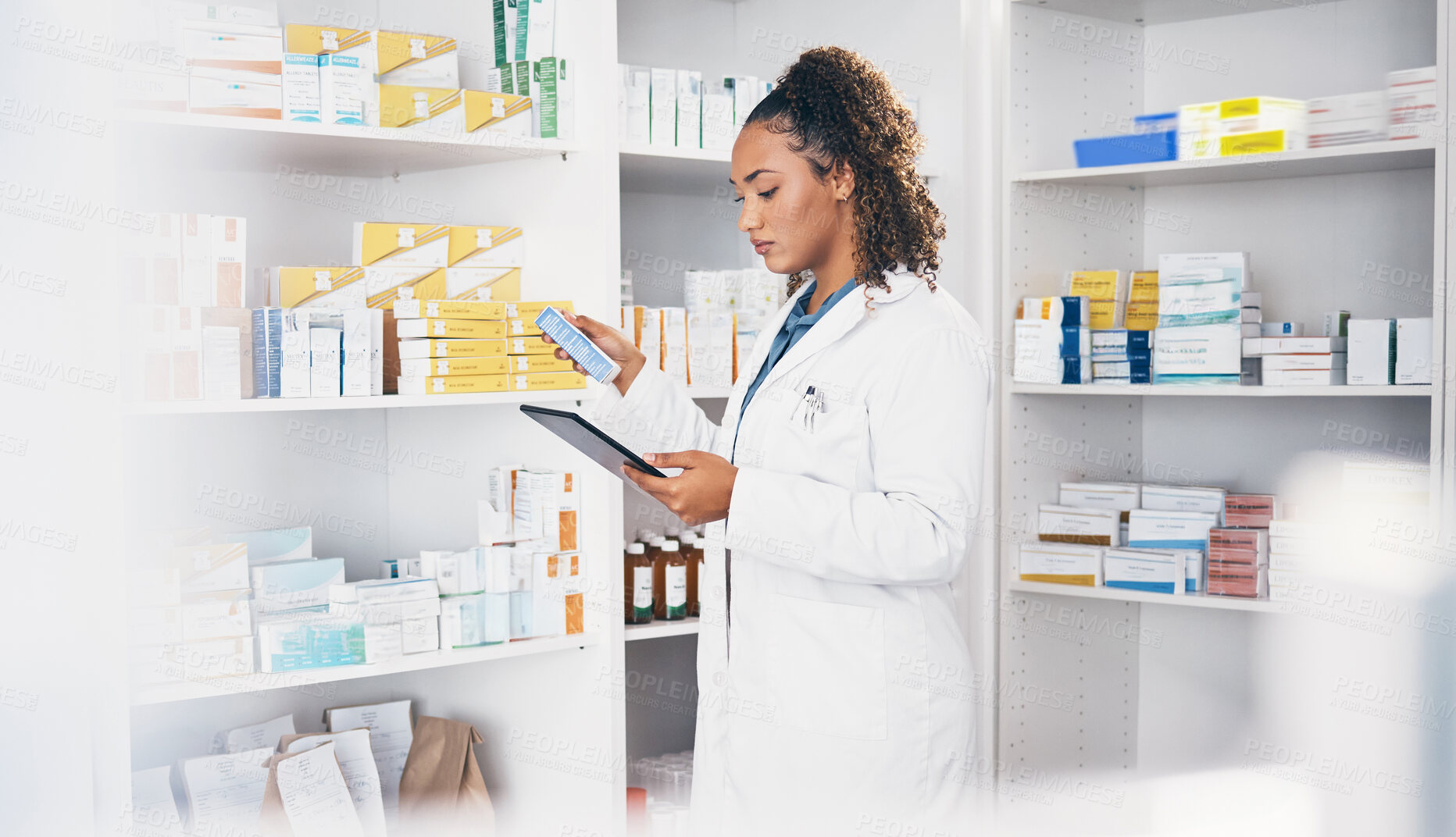 Buy stock photo Tablet, stock and medication with a woman in a pharmacy to fill an online order of prescription treatment. Healthcare, product or insurance with a female pharmacist working as a medicine professional