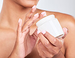 Skincare, closeup and woman with jar of face cream for cosmetic, natural and health routine. Wellness, beauty and zoom of model hands with dermatology spf, sunscreen or lotion by a studio background.