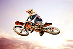 Sky background, motorcycle and jump for training or sports with fitness, balance or challenge in nature on mock up space. Bike, freedom and adventure for competition and exercise with safety gear
