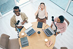 Radio, podcast or broadcast with a content creator team in their office from above for streaming or recording. Laptop, microphone and influencer friends in the studio together on a creative platform