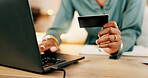 Laptop, credit card and woman hands for business online shopping, transaction or fintech payment in night office. Professional black person typing her banking information on computer or financial app