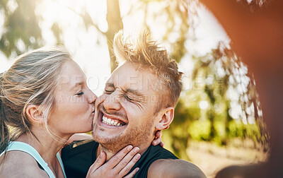 Buy stock photo Couple, selfie and exercise with kiss, nature and fitness together with photo for social media. Smile, happy and excited from love, bonding and workout in woods with profile picture in forest