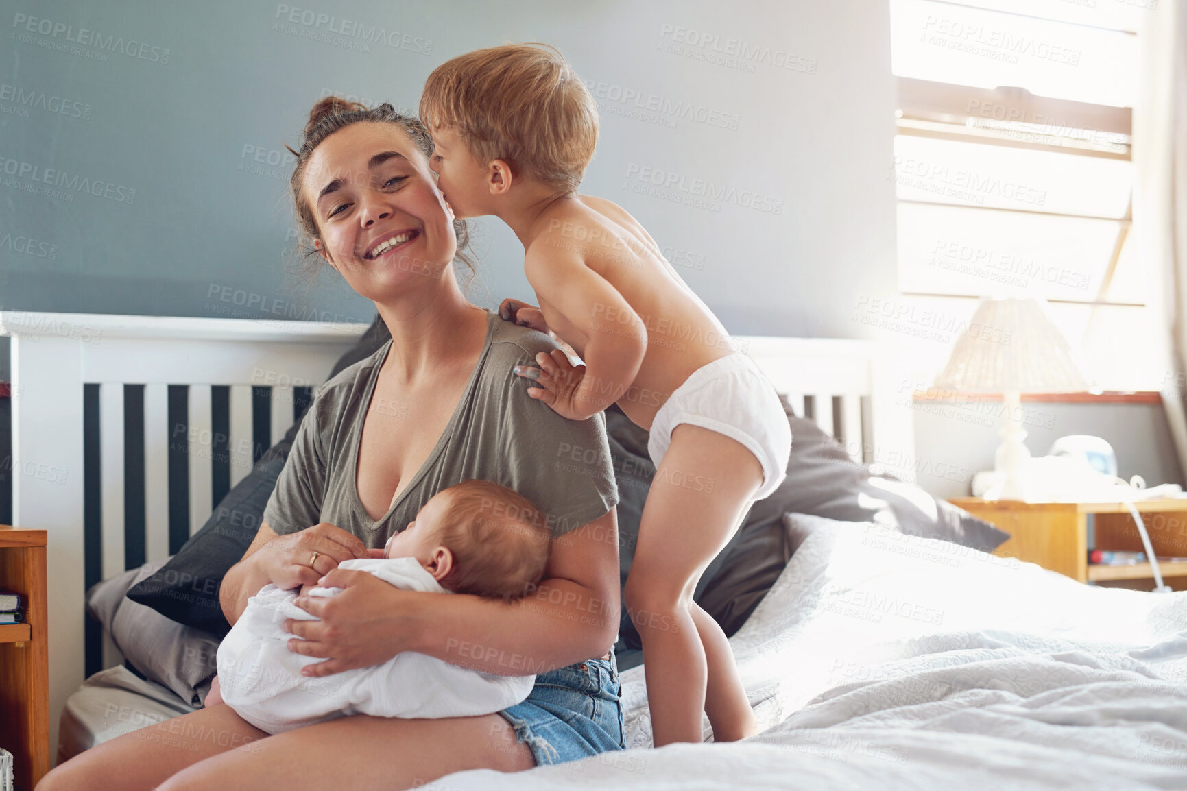 Buy stock photo Mother, children and baby in house bedroom, new born and toddler son or kiss woman for family home affection. Happy, together and bonding with love, smile and morning apartment for childhood care