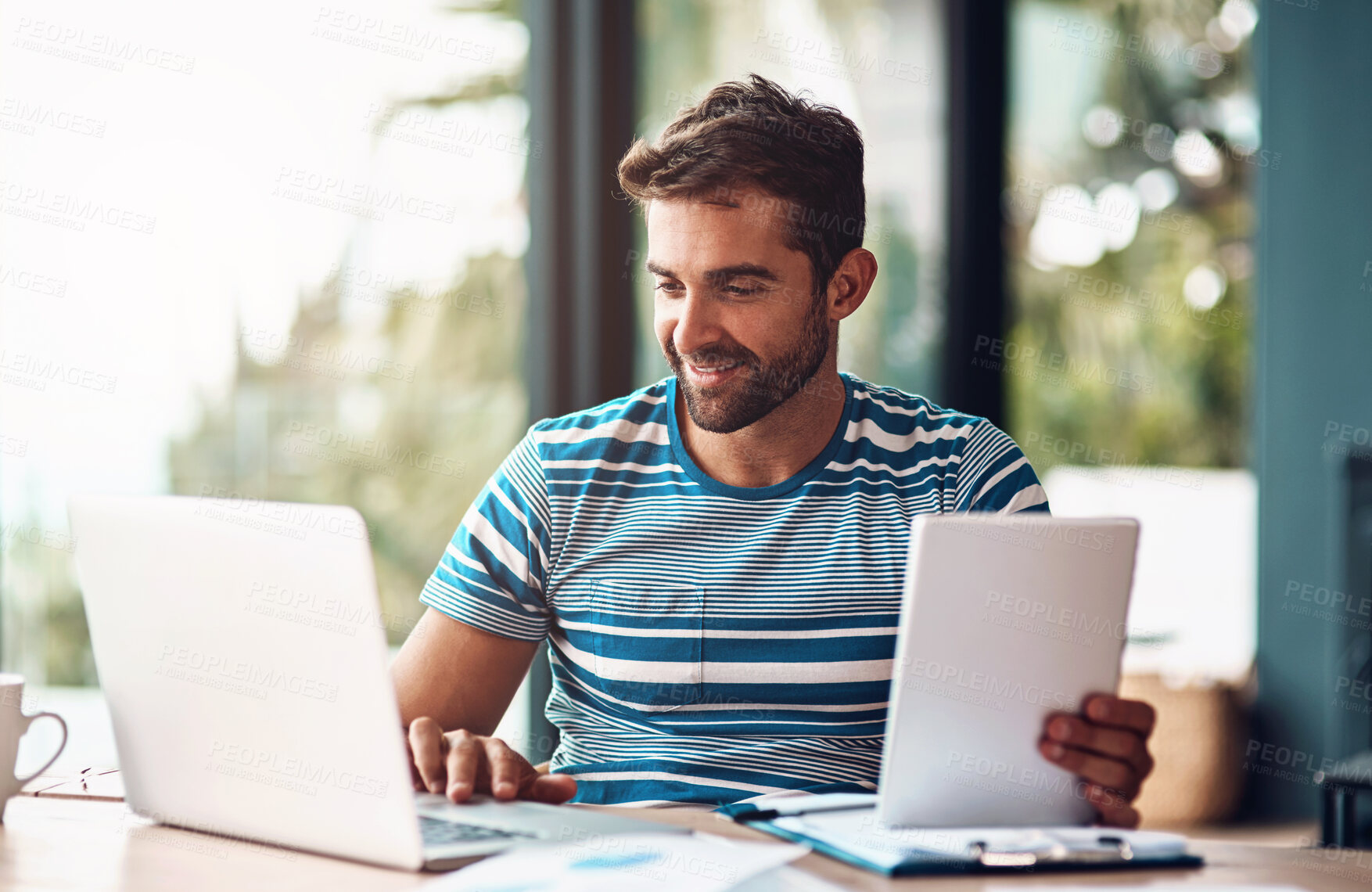 Buy stock photo Laptop, man and tablet for planning at desk, home and office for online business. Technology, design and website development for creative person, computer or work from house for designer entrepreneur