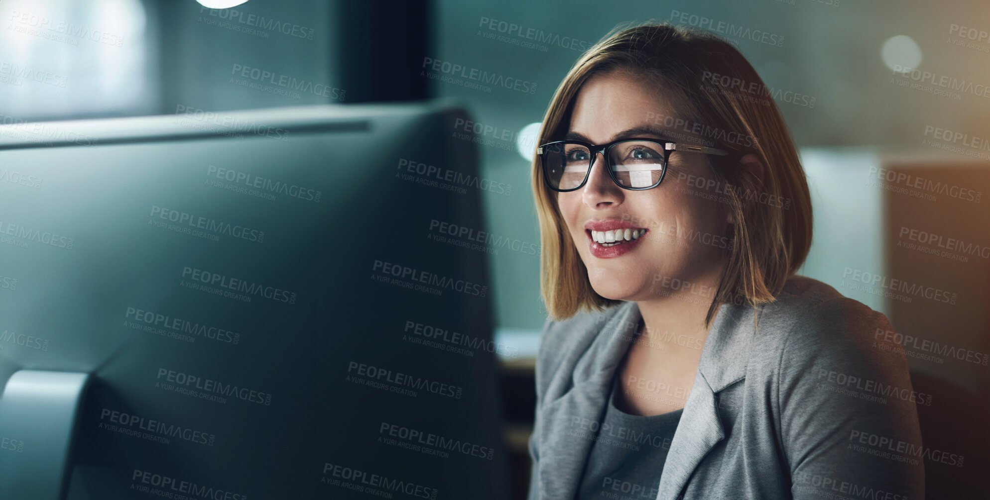 Buy stock photo Woman, employee and happy on computer in office for internet, online and research for ideas. Female person, smile and satisfied at night with deadline or overtime, project and glasses as copy writer