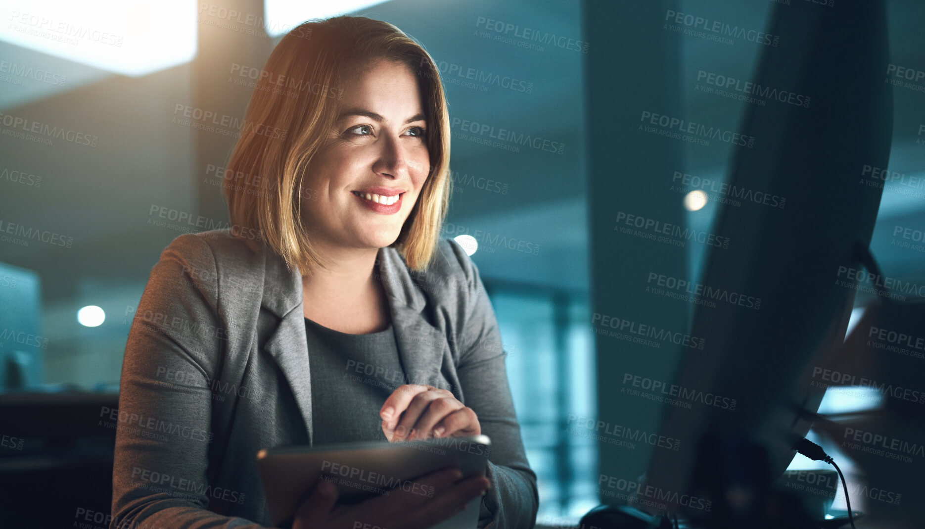 Buy stock photo Happy woman, tablet and night with computer for deadline, project or tasks on agenda at office desk. Female person or web designer working late with smile on technology for innovation at workplace