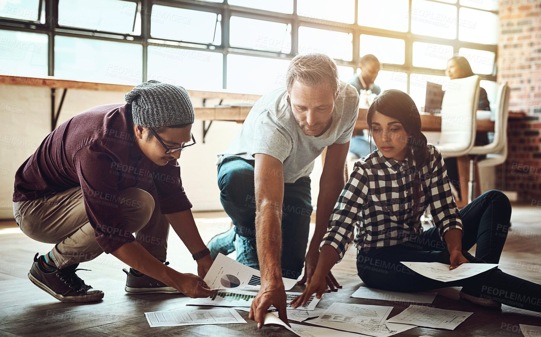 Buy stock photo Floor, people and meeting with charts and graphs in office for planning fashion design budget and fabric. Creative professionals, designer group and brainstorming with paper and ideas for teamwork