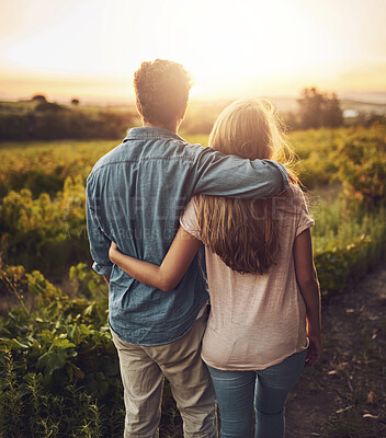 Buy stock photo Back, hug and couple in morning, outdoor and together with care, field and date for anniversary in love. Sunrise, partner and person with embrace, nature and peace in grass and relax in Texas in farm