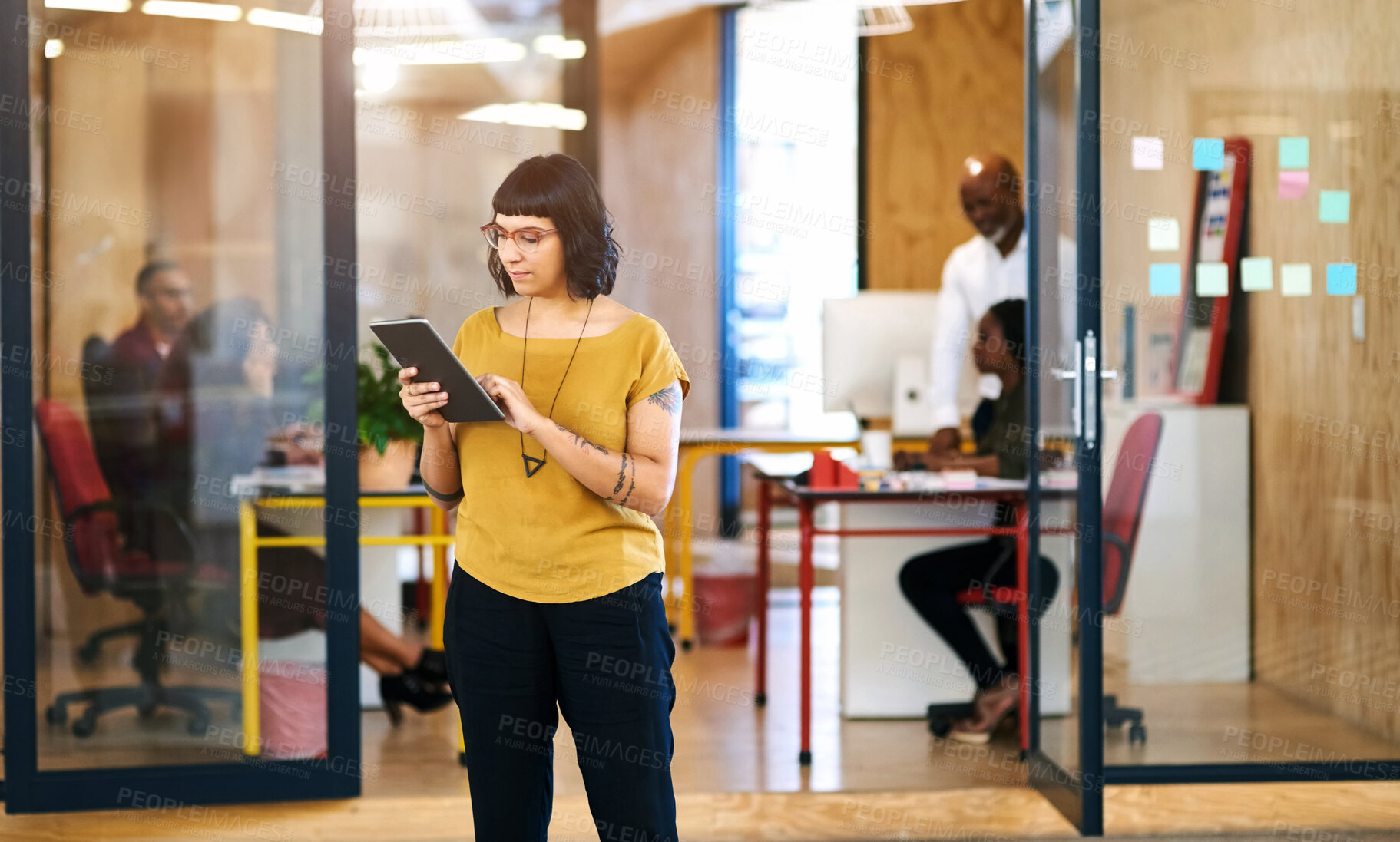 Buy stock photo Woman, tablet and corridor at startup office with thinking, typing and check notification on web. Person, internship and digital touchscreen with ideas, click and reading with app at creative agency