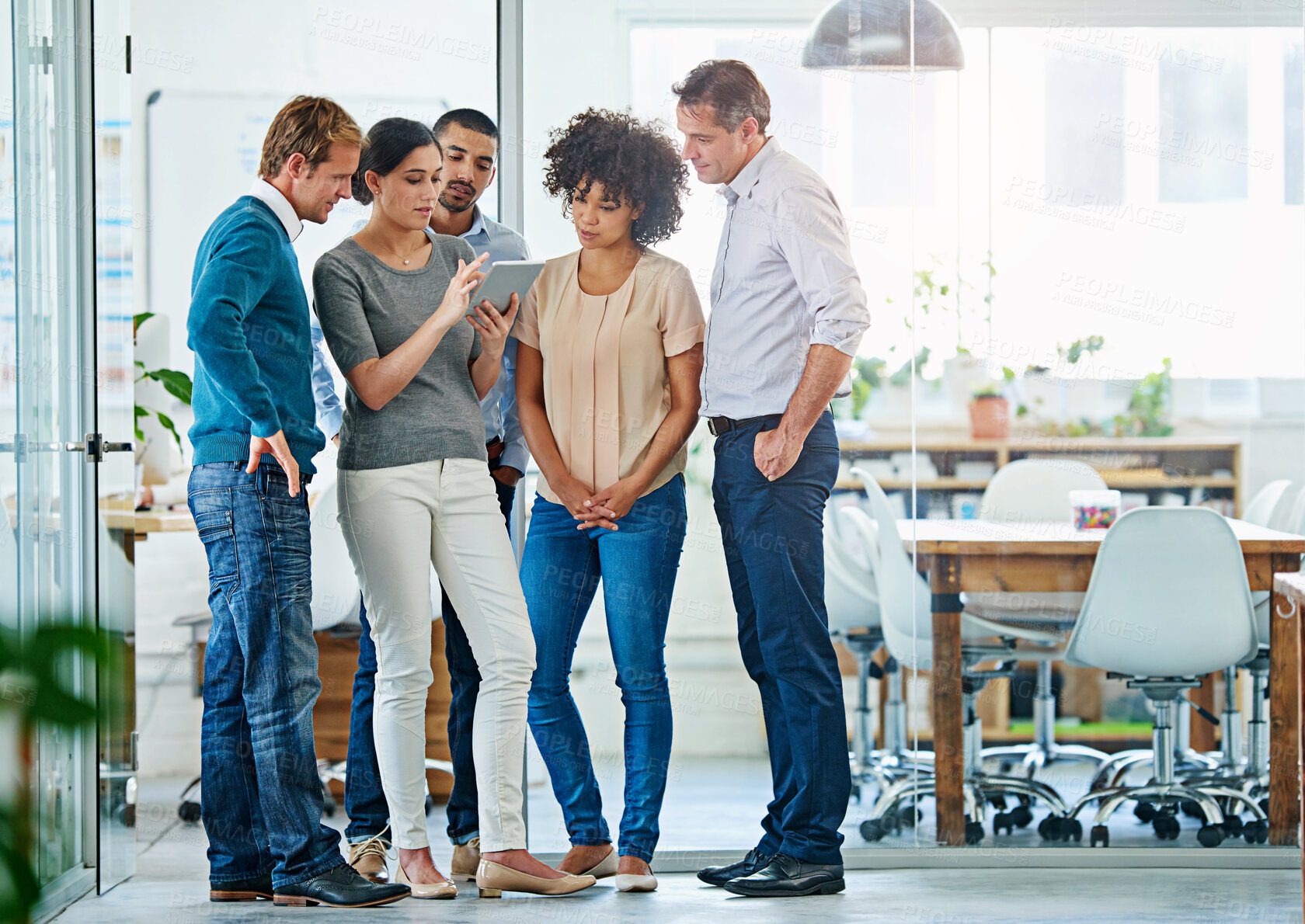 Buy stock photo Business people, team and discussion with tablet for project, collaboration or communication at office. Group of young creative employees working with technology for research, development or startup