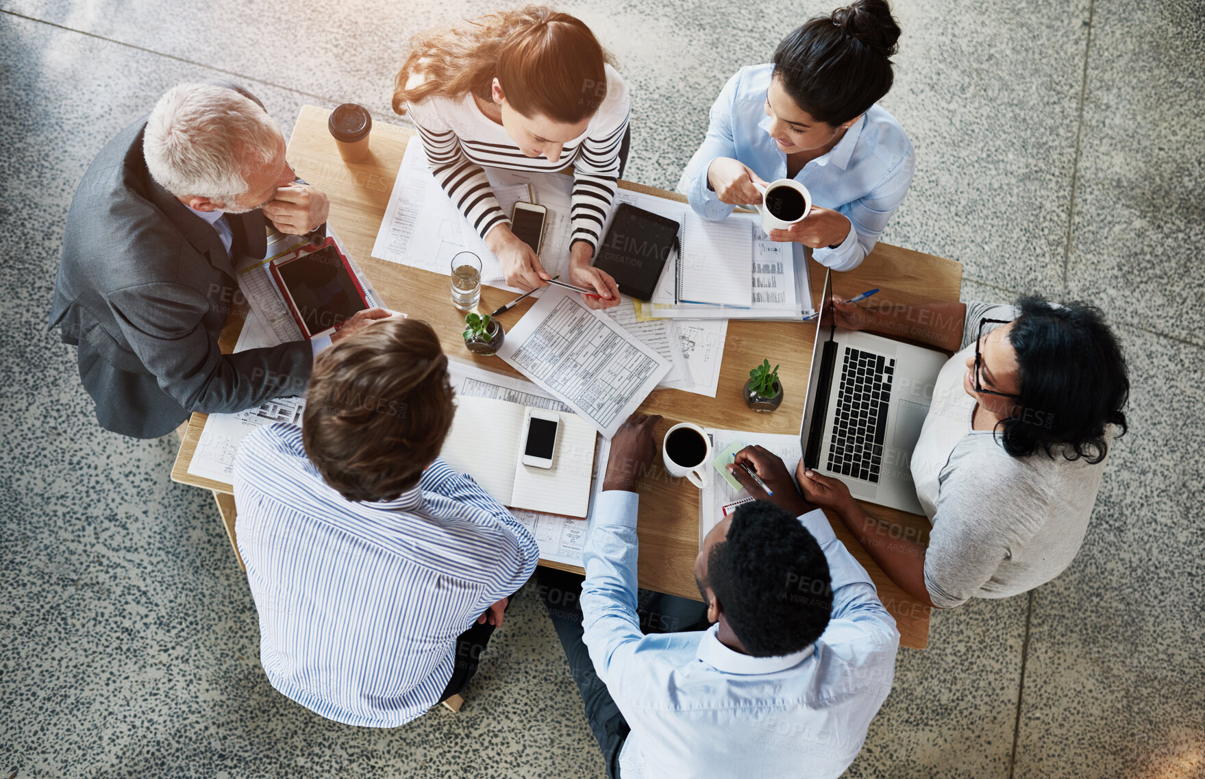 Buy stock photo Top view, business people and planning in meeting, teamwork and cooperation with brainstorming. Group, staff and employees with documents, technology and morning coffee with ideas and collaboration