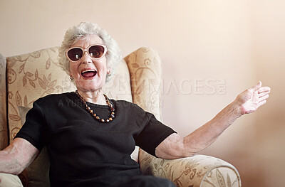 Buy stock photo Senior, woman and happy with sunglasses in home on sofa with fun retirement, laughing and relax in living room. Elderly, person and excited with eyewear on couch in hospice with wellness and funny