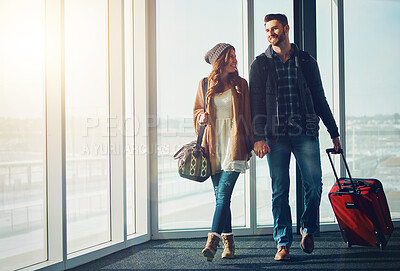 Buy stock photo Suitcase, travel and walking with couple in airport together for overseas journey, trip or vacation. Love, luggage or smile with man and woman tourist holding hands n lobby for boarding flight