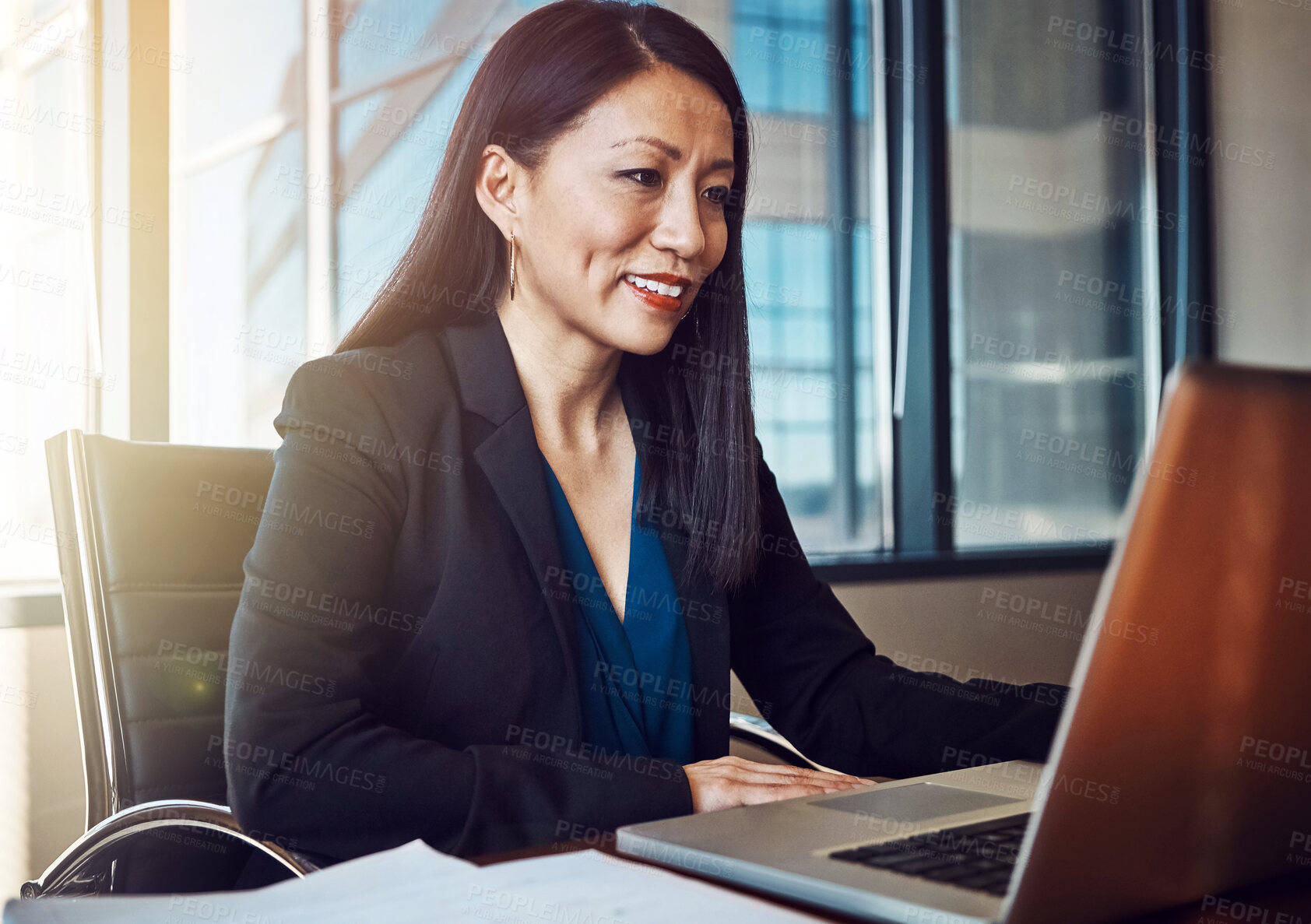 Buy stock photo Japanese lawyer, woman and laptop for reading, review or smile for legal report by documents in office. Attorney, advocate or person by computer, web or research for compliance at corporate law firm