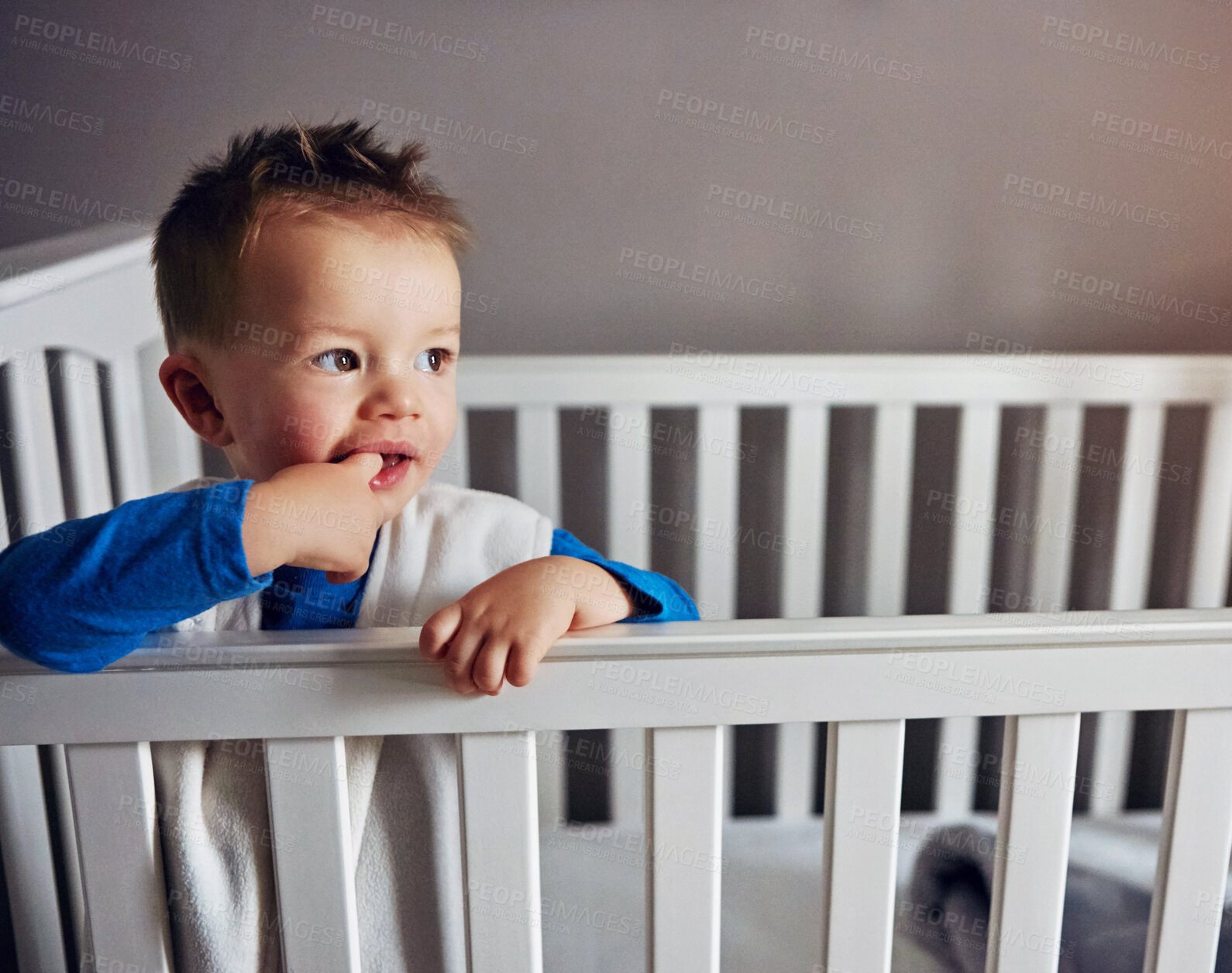 Buy stock photo Baby, morning and crib in house bedroom with wake up, growth and child development for teething. Toddler, tired and bassinet in home for sleeping, wellness and childcare of kid with finger in mouth
