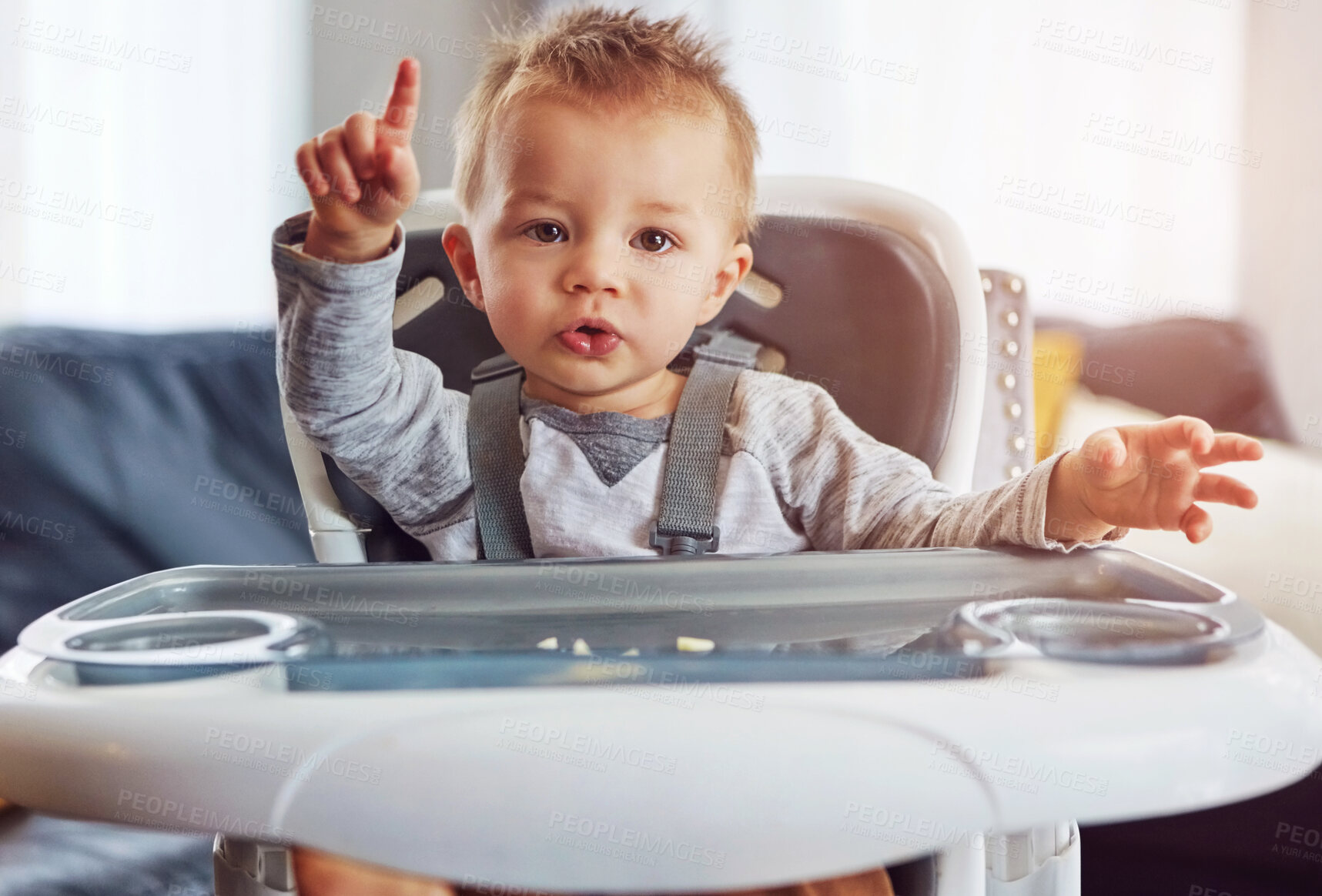 Buy stock photo Baby, high chair and home in portrait for learning or wellness, motor skills with finger for growth. Young, boy child and hand in house for healthy development, waiting for meal time in apartment