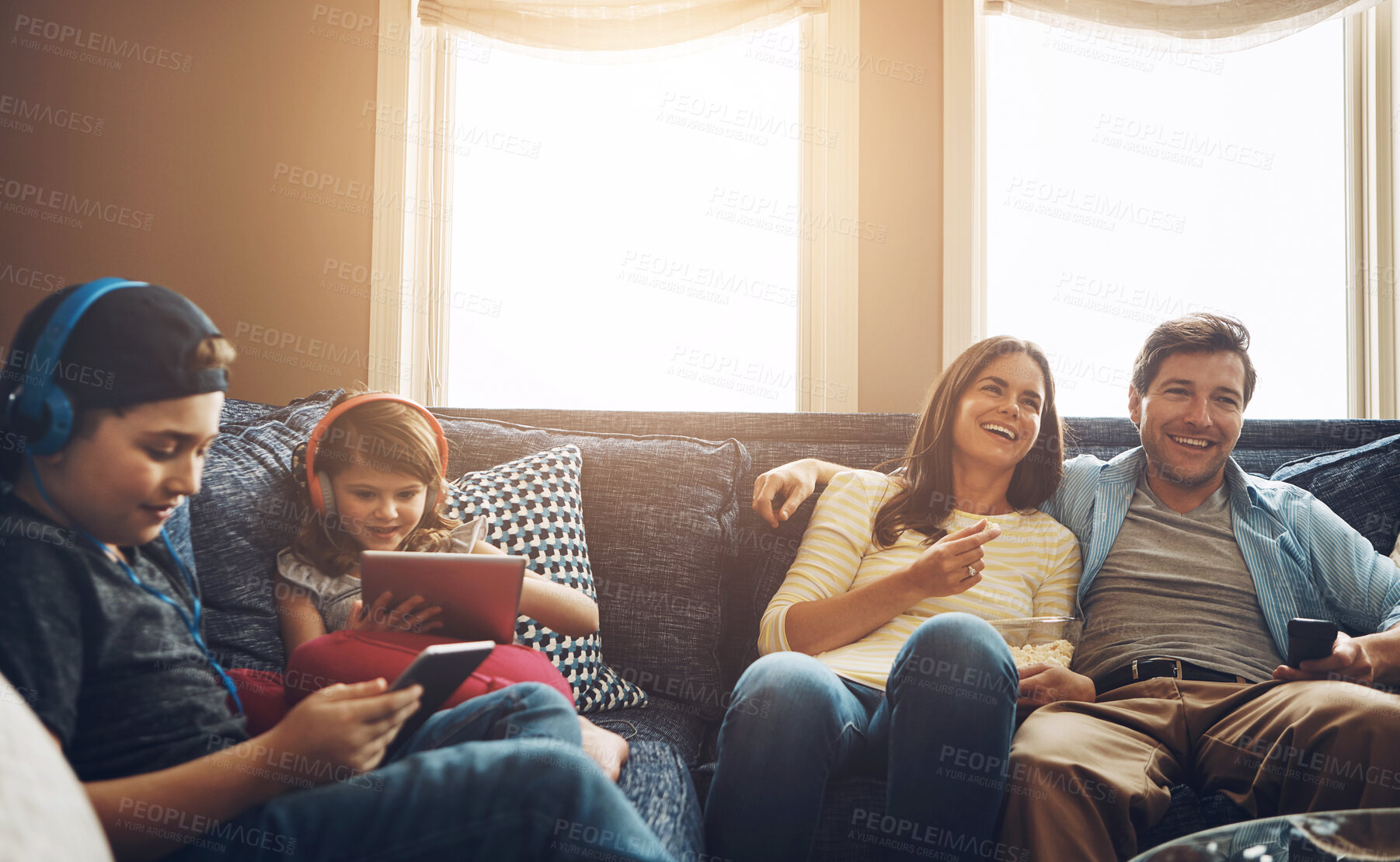 Buy stock photo Family, children and parents with tablet on sofa, watching tv and streaming with bonding in living room. Mother, father and kids with headphones, subscription and movies with smile in lounge at house