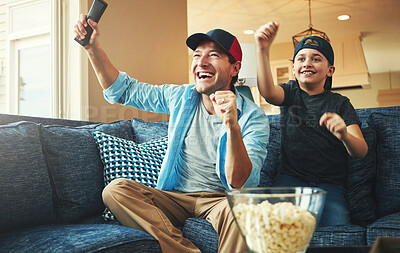 Buy stock photo Television, kid and man with celebration on sofa for streaming, subscription and watching together. Son, dad and popcorn with tv remote in fist for bonding, success and live broadcast of sports match