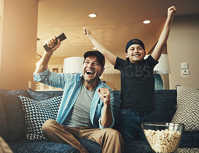 Buy stock photo Television, child and dad with success on sofa for network, subscription and watching sports together. Son, man and popcorn with tv remote in fist for celebration, bonding or live broadcast and match