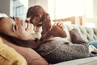 Buy stock photo Happy, relaxing and woman with dog on sofa bonding with pet in living room at apartment. Smile, animal and female person cuddle, hug and embrace puppy with love and care on couch in lounge at home.