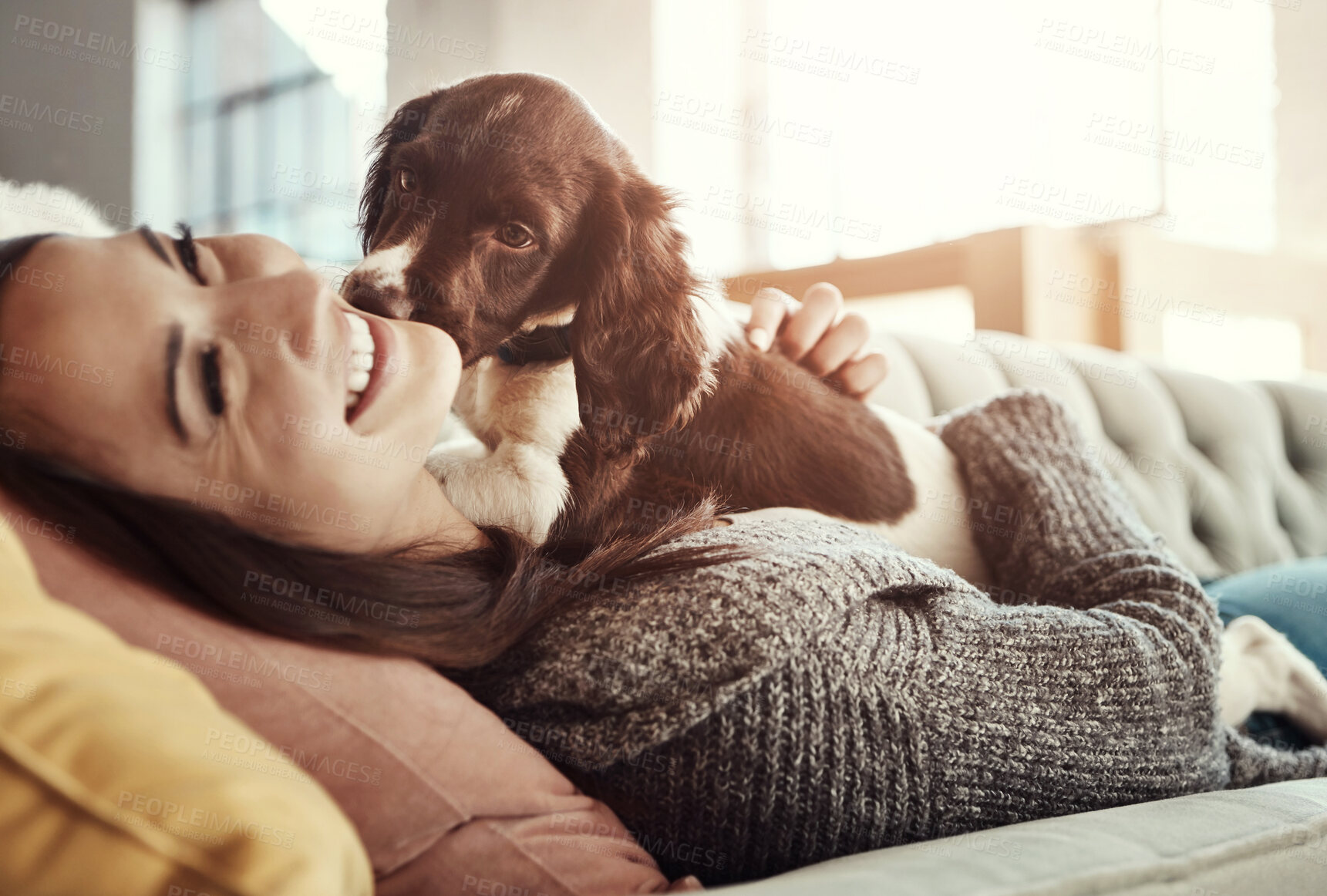 Buy stock photo Happy, relaxing and woman with dog on sofa bonding with pet in living room at apartment. Smile, animal and female person cuddle, hug and embrace puppy with love and care on couch in lounge at home.