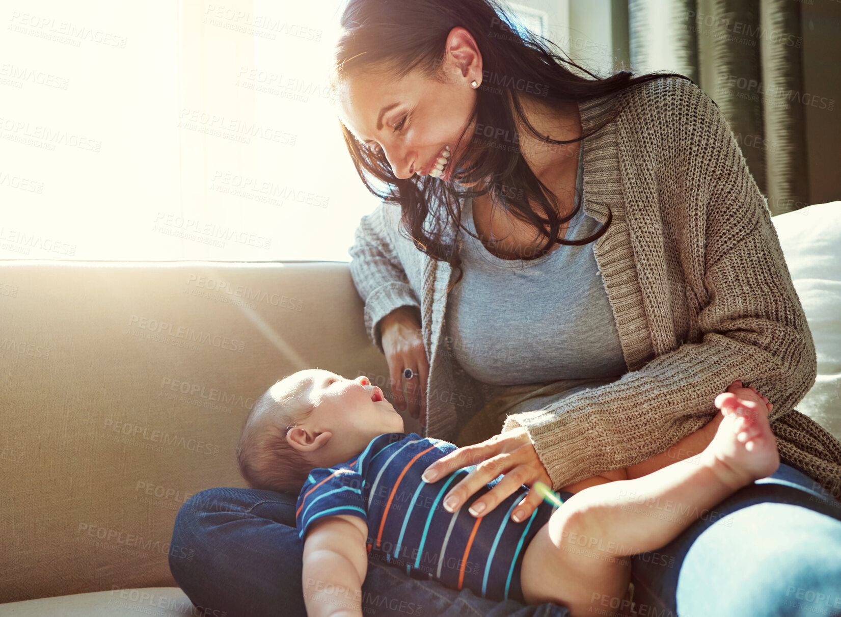 Buy stock photo Happy, mother and baby on sofa relax on weekend for love, bonding and relationship development in home. Care, woman and child together on couch in summer for safety, support or playing in living room