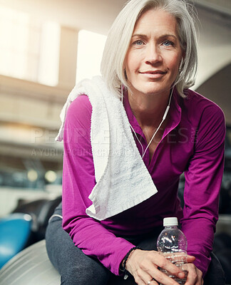 Buy stock photo Woman, portrait and bottle in gym on ball for break, hydration and tired from workout for wellness. Mature person, water and relax with pride, fatigue and smile with towel at training for fitness