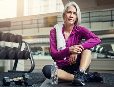 Buy stock photo Mature woman, portrait and water on gym floor for break, hydration or tired from workout for wellness. Person, bottle and relax on mat with pride, fatigue and rest for training, exercise and fitness