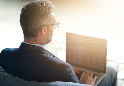 Buy stock photo Businessman, glasses and remote work with laptop on sofa, professional website development for company. Male manager, couch and computer with lens flare for digital job, creative designer from behind