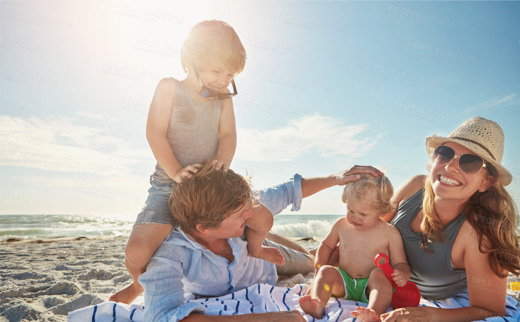 Buy stock photo Portrait, relax or kids with parents at beach on holiday vacation or happy family weekend together. Father, fun mother or children siblings at sea for bonding or playing in nature in Spain with love