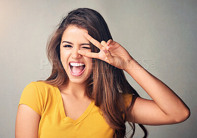 Buy stock photo Peace sign, wink and portrait of girl, studio and happiness with mouth, crazy and smile for results of test. Student, woman and Gen z with joy for college acceptance, white background and New York