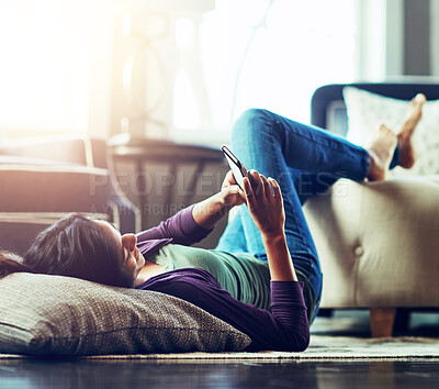 Buy stock photo Woman, relax and lying with phone on floor for communication, social media or reading news at home. Female person on mobile smartphone for online browsing, chatting or texting in living room at house