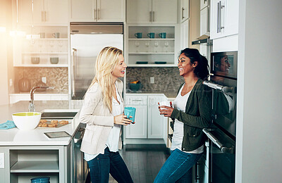 Buy stock photo Home, friends and women with conversation, relax and happiness in kitchen, morning coffee and weekend break. Catch up, apartment and girls in house, tea and talking with discussion, smile and reunion