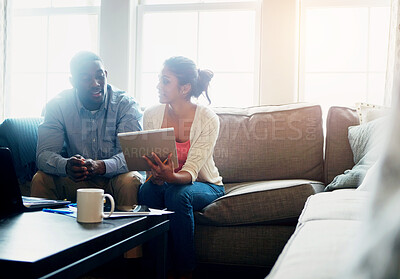 Buy stock photo Couple, tablet and browsing on sofa in morning for work, payments and rent with tax in living room. Technology, coffee and sunlight with people on couch, cover and debt with finance for mortgage.