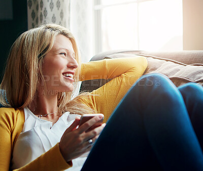 Buy stock photo Home, relax and woman on couch, smartphone and thinking with smile, funny and social media. Person, apartment and girl with cellphone, internet and connection with website info, texting and laughing