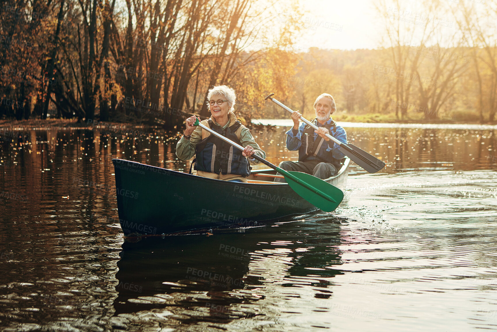 Buy stock photo Lake, rowing and kayak with old couple, sunshine and retirement with happiness, river and vacation. Outdoor, nature and mature man with senior woman, support and love with holiday and getaway trip